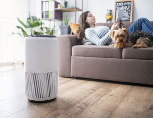 woman using personal air purifier at home