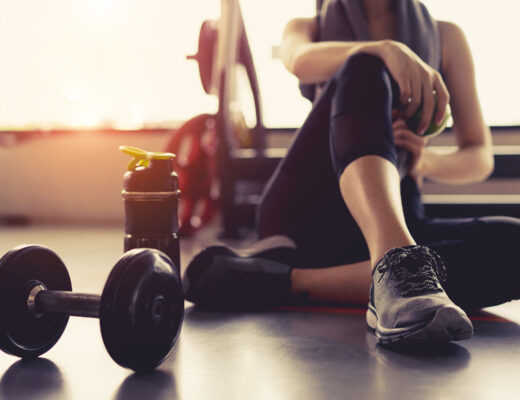 woman in gym working towards health goals