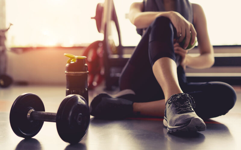 woman in gym working towards health goals